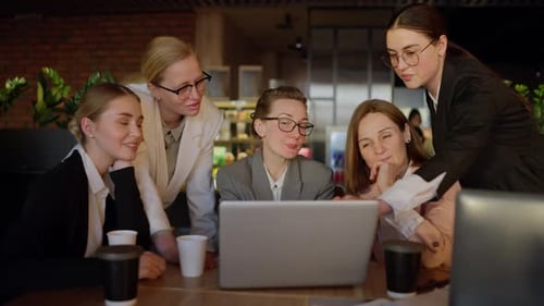 Female Team Collaborating on Laptop in Office