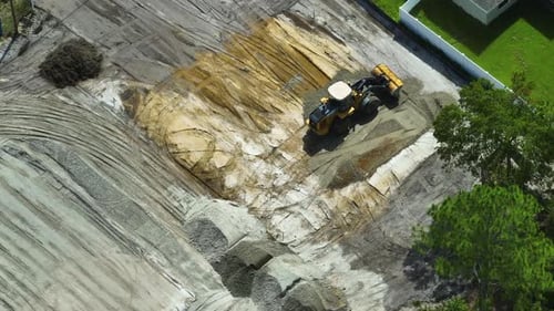 Bulldozer Smoothing Gravel on Construction Site Aerial