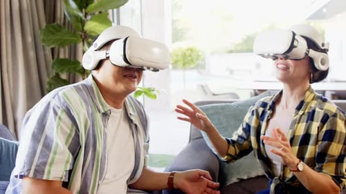 Adults Using VR Headsets in Modern Home