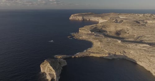 Aerial view of rugged Gozo cliffs and Dwejra Bay, Munxar, Malta.