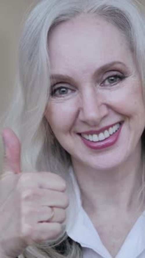 Attractive Woman Gives Thumbs Up for Approval, Close-up