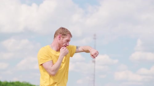 Man Practicing Boxing Moves in Scenic Park on a Sunny Afternoon