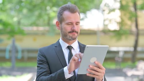 Man Using Tablet in Urban Setting