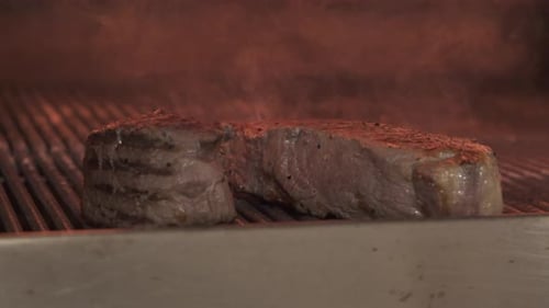 Juicy Steak Sizzling on Hot Grill