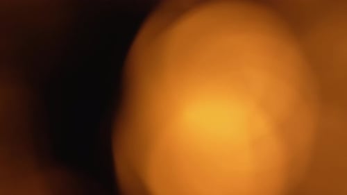Defocused Golden Glowing Light Effects on Black Background