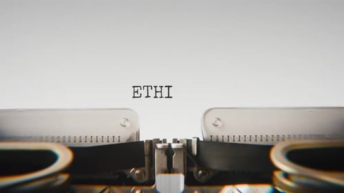 Old mechanical typewriter typing Ethics in a close-up view.