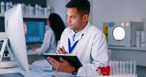 Scientist Reviews Data in Modern Laboratory Setting