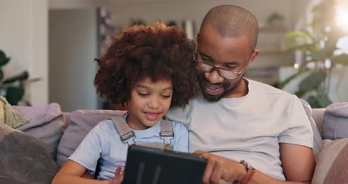 Father, boy and relax with tablet on sofa at house by reading online ebook