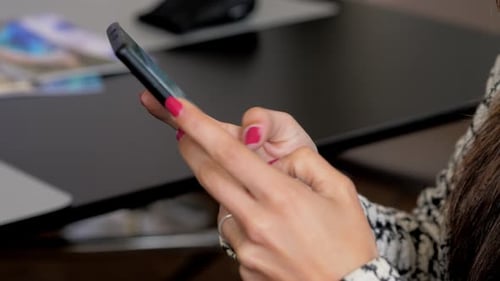 Close up of young woman using smartphone at home