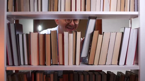 Librarian Searching for Book on Bookshelf in Library
