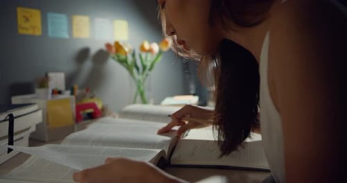 Young Woman Studies Indoors at Night