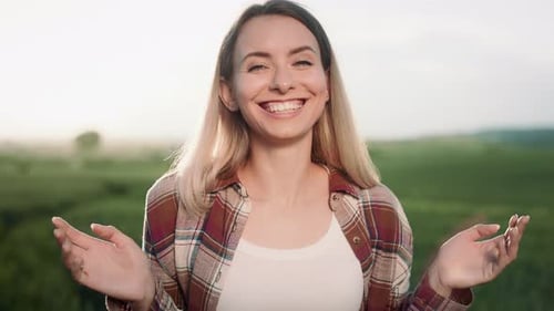 Smiling Woman Standing in a Sunny Rural Field