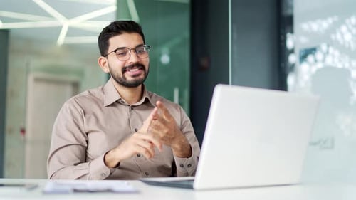 Young Adult on Video Call in Modern Workplace