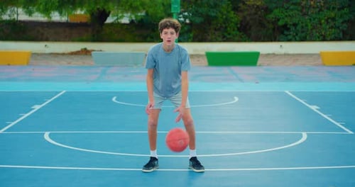 Slow Motion Street Basketball Boy Practicing Shooting a Basketball The Teenager Plays Basketball