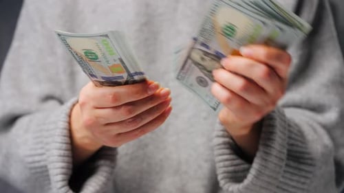 Close Up Hands Counting Stacks of Cash