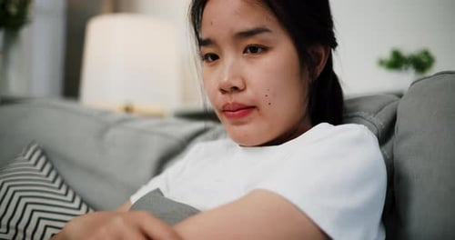 Young Adult Relaxing on Couch at Home