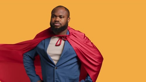 Man Wearing Cloak Posing As Superhero in Costume Studio Background