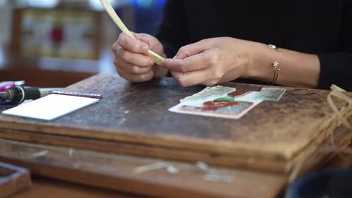 Artist Assembling Stained Glass at Workbench