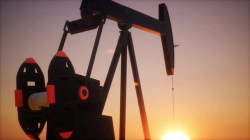 Pumpjack Operating At Sunset During Oil Extraction Process In The Field