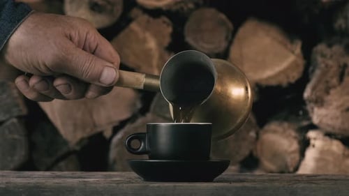 Turkish Coffee. Pouring coffee from cezve into cup