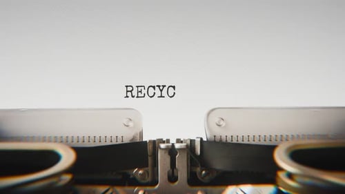 Old mechanical typewriter typing Recycling Process in a close-up view.