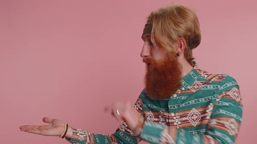 Hippie Man Showing Thumbs Up and Pointing Empty Place Advertising Area for Commercial Text Promotion