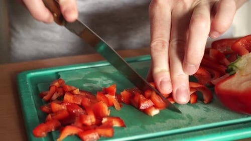 Hands Dicing Red Bell Pepper on Cutting Board