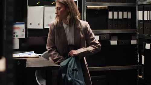 Woman Working at Desk in Dimly Lit Office