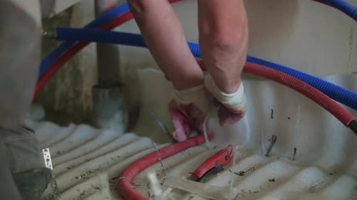 Plumber Connecting Red and Blue Pipes