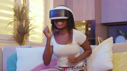 Woman Uses Virtual Reality Headset on Couch