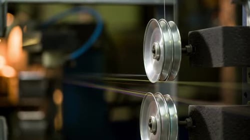 Machine Pulling Thin Wire Through Rollers in Factory