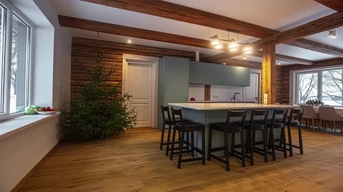 Panning from the doorway to view an open concept kitchen and great room in a luxury model home