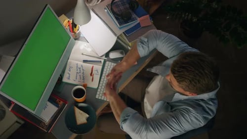 Workaholic Man Typing at Green Screen Device