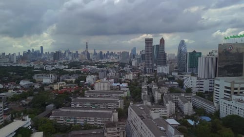 Overflight of buildings of the suburb in the background cloudy sky line of the city. Fabulous aerial