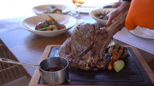 Delicious steak being sliced at a restaurant