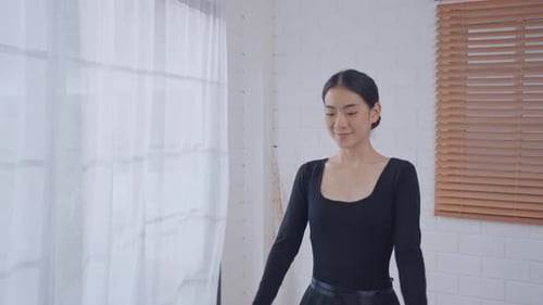 Young Woman Practices Ballet in Bright Room