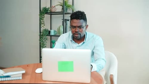 Serious Man Programmer Coding on Laptop