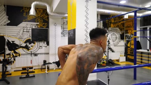 Strong African Man Doing Push Ups on Parallel Bars at Sport Club Muscular Afro American Sportsman