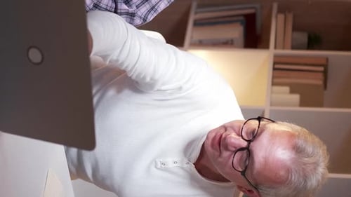 Two People Working Together Inside the Home