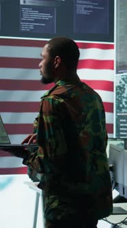Man in Uniform Working on Laptop in Office