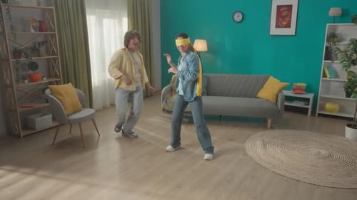 A Young Married Couple Spends Time Together Having Fun A Couple is Playing a Game of Blind Man's
