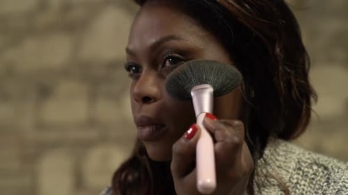 Woman Applying Makeup With A Brush