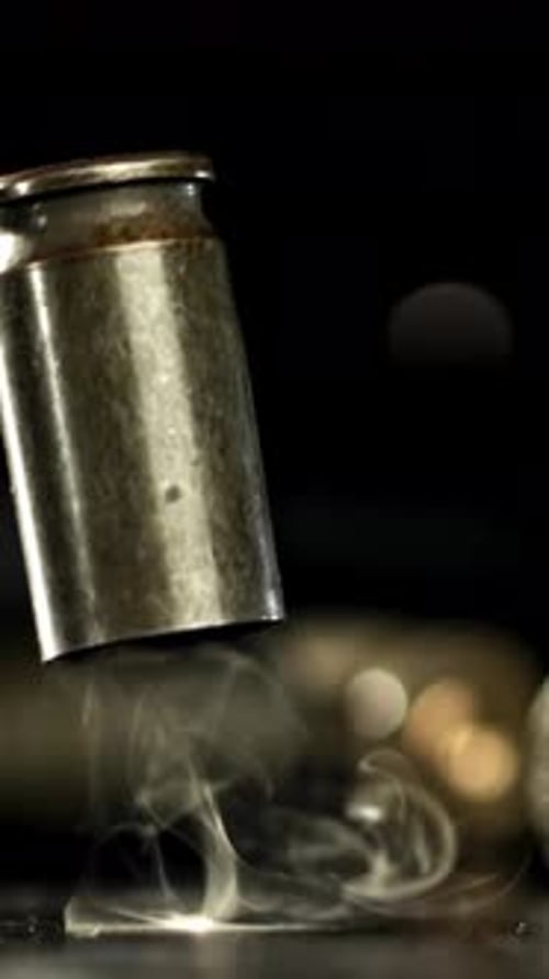 Cartridges From a Pistol Shot Fall to the Floor Filmed on a Highspeed Camera at 1000 Fps