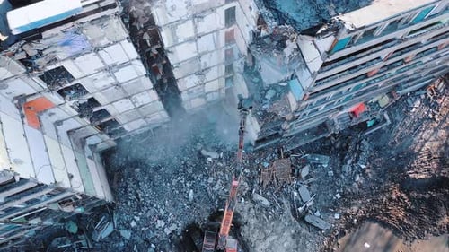 Construction of destroyed house. Destructive demolition building by excavator.