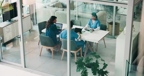 Doctors, meeting and discussion in boardroom at clinic, above and review with laptop