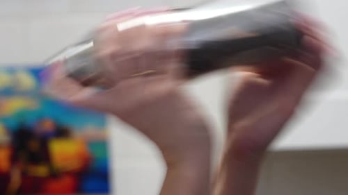 Female Bartender Shakes Cobbler Cocktail Shaker Close Up of Hands with Silver Tin and Pink Nail Pol