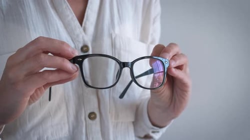 Female Hold Eyeglasses with Black Frame