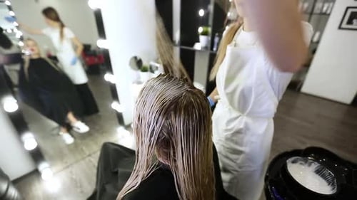 Hair Stylist Applying Dye at Modern Salon