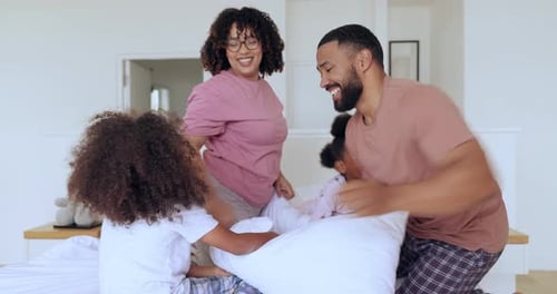 Family Pillow Fight Fun in Bright Bedroom