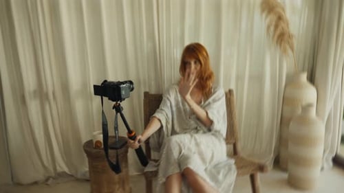 Woman Sits and Records Video on Camera